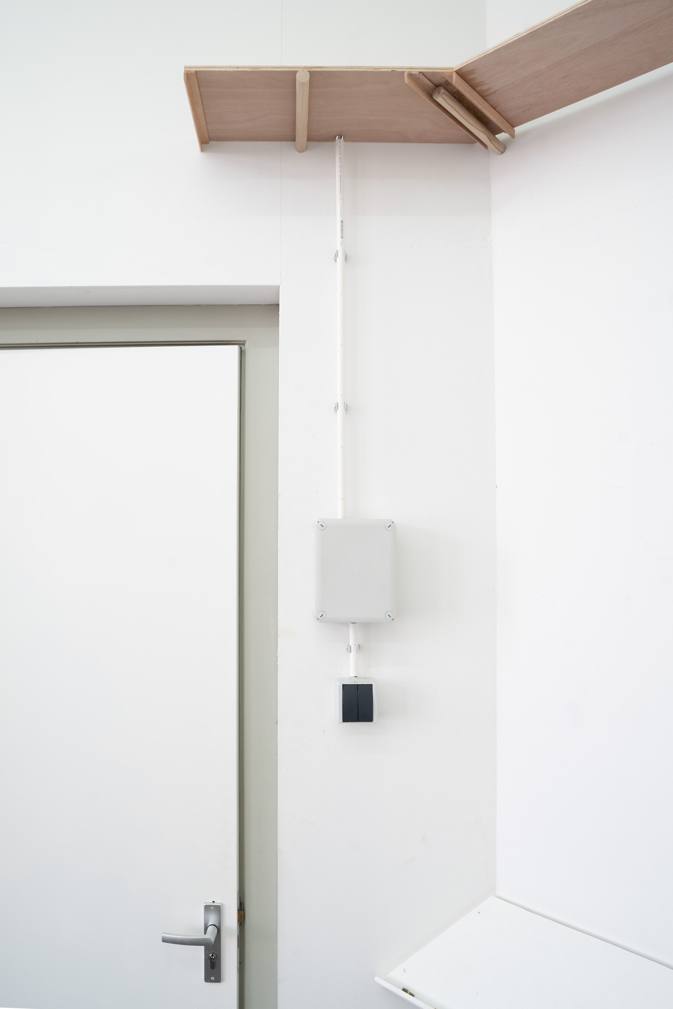 Marissa Lee Benedict and David Rueter, a conversation between machines about Mallarmé (regarding the state of the gallery lights), 2023, Wooden shelf, receipt printer, thermal paper, wiring and conduit, custom software, annotated text file containing Stéphane Mallarmé's poem "Un coup de dés jamais n'abolira le hasard," Large Language Model (LLM) cloud service account, single-board computer.