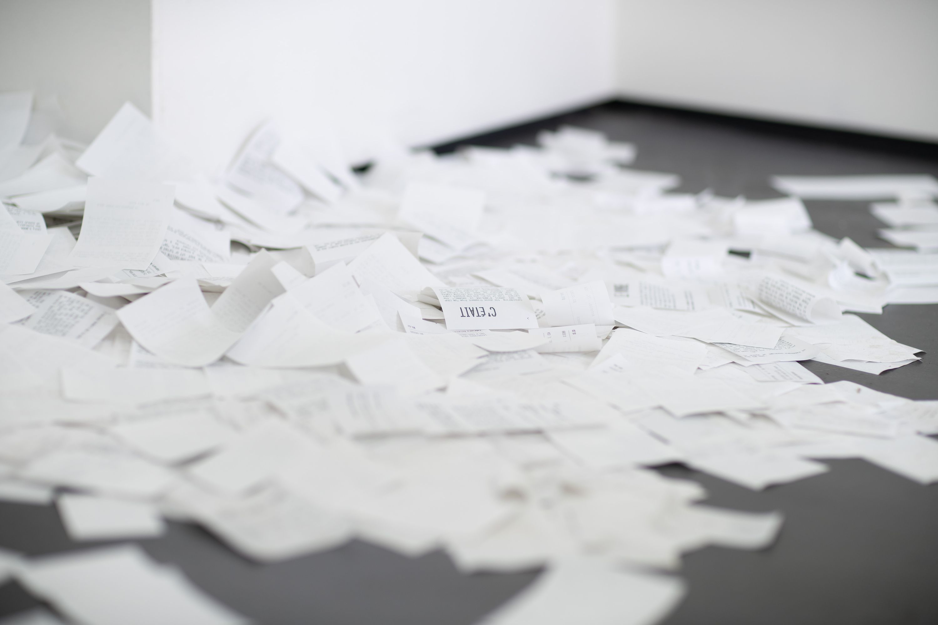 Marissa Lee Benedict and David Rueter, a conversation between machines about Mallarmé (regarding the state of the gallery lights), 2023, Wooden shelf, receipt printer, thermal paper, wiring and conduit, custom software, annotated text file containing Stéphane Mallarmé's poem "Un coup de dés jamais n'abolira le hasard," Large Language Model (LLM) cloud service account, single-board computer.