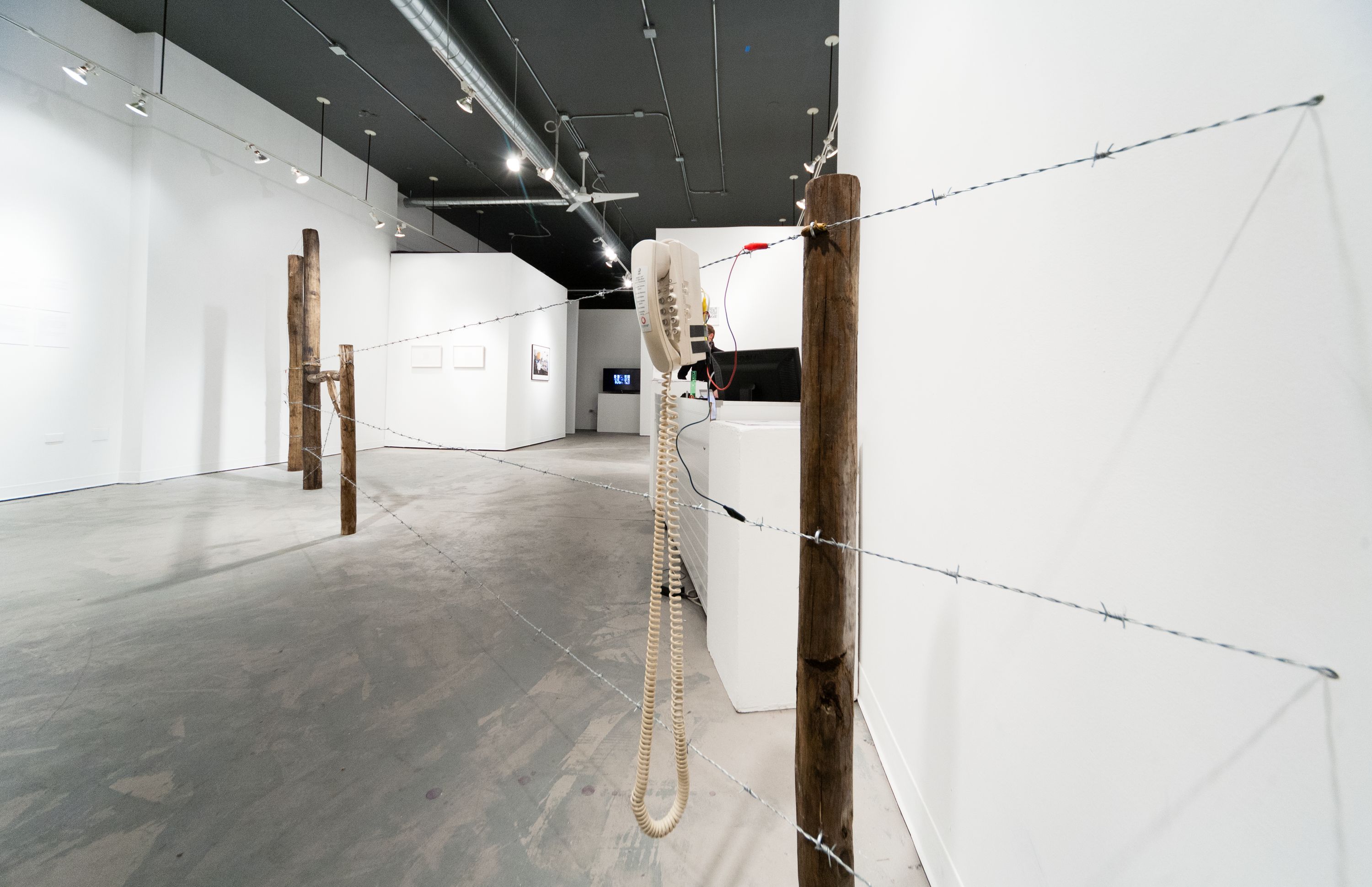 Phil Peters and David Rueter, Barbed Wire Fence Telephone, 2014, Wood, barbed wire, telephones, batteries, electrical wire